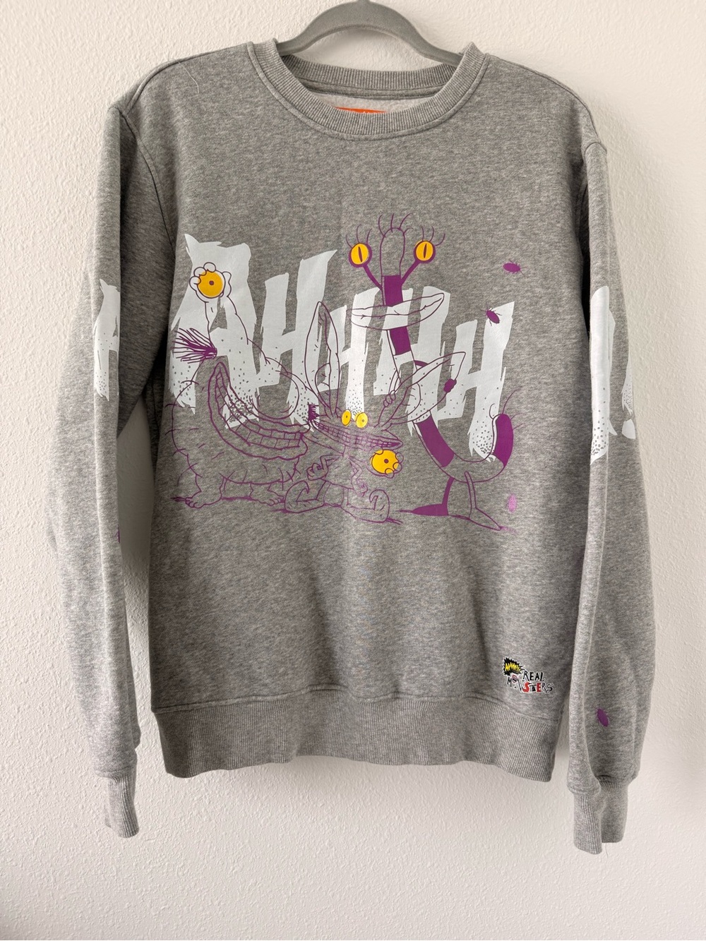 Nickelodeon Grey Crewneck Sweatshirt with Purple Character Art and Yellow Eyes